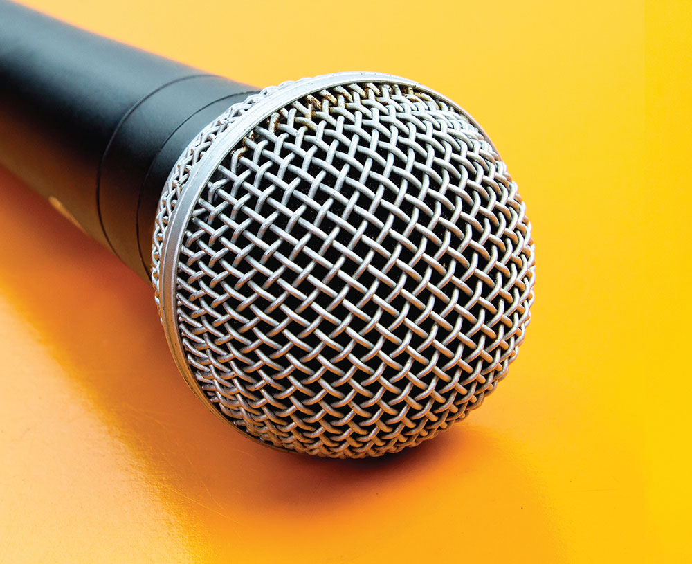 Photo of a microphone against a yellow background