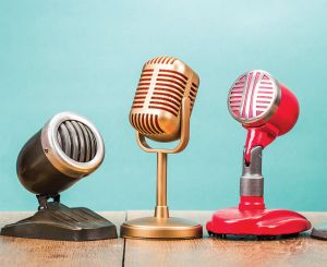 Three different types of retro microphones against teal background